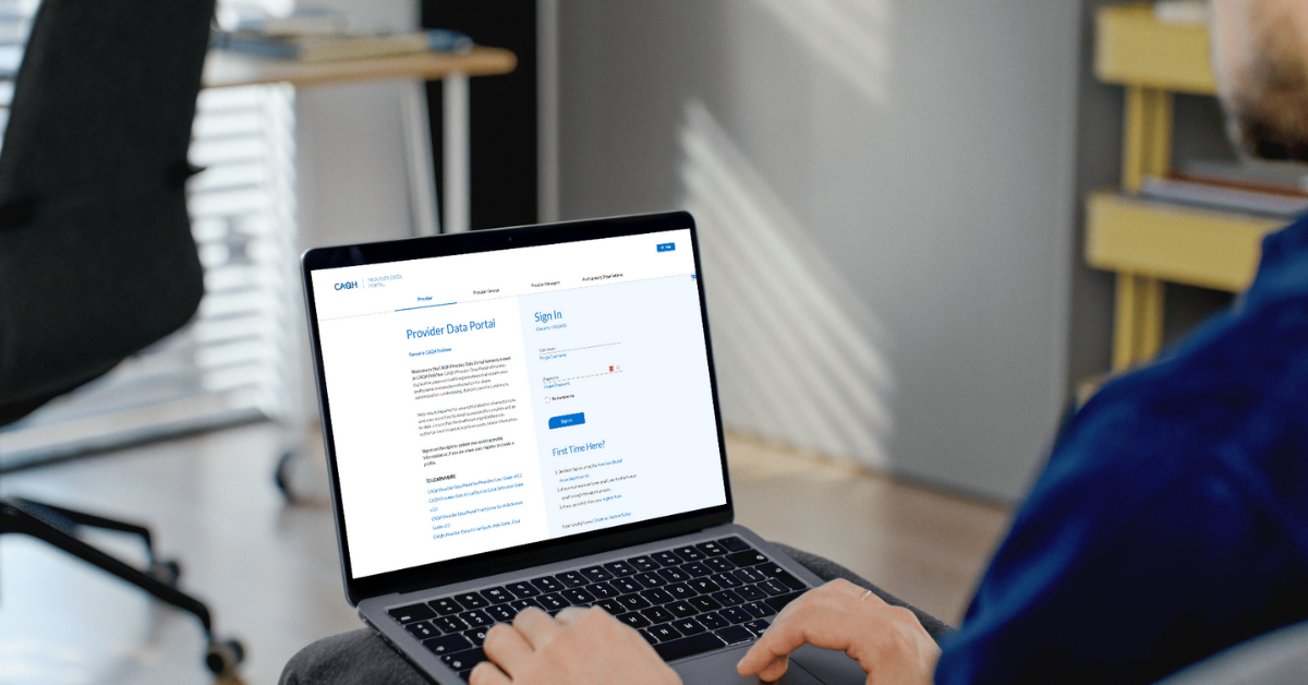 Laptop screen showing the CAQH provider login dashboard